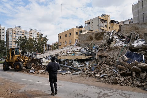 A bulldozer clears debris from the rubble of buildings destroyed in an Israeli airstrike, in Dahiyeh, Beirut's southern suburbs,, Lebanon, Monday, March 16, 2026. 