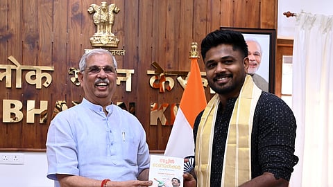 Governor Rajendra Arlekar presenting a copy of Sachin Tendulkar's autobiography
'Playing It My Way' to cricketer Sanju Samson at the Kerala Lok Bhavan