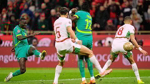 Senegal's Pape Gueye, left, scores the opening goal during the Africa Cup of Nations final soccer match between Senegal and Morocco, in Rabat, Morocco, Jan. 18, 2026. 