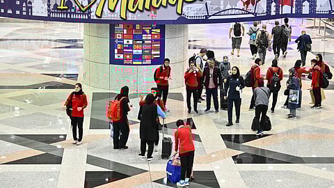 Members of Iran's women's football team walk at the Kuala Lumpur International Airport in Sepang on March 16, 2026, after staying in a hotel in the Malaysian capital while awaiting the next leg of their journey home.