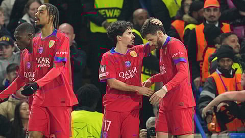 PSG's Khvicha Kvaratskhelia, right, celebrates with PSG's Vitinha after scoring his side's opening goal during the Champions League soccer match between Chelsea and Paris Saint-Germain in London, England, Tuesday, March 17, 2026.
