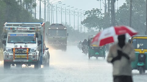 Citizens witnesses a sudden downpour in Vijayawada on Wednesday.