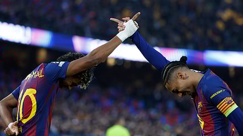 Barcelona's Raphinha, right, celebrates with teammate Lamine Yamal after scoring the opening goal of his team during the Champions League round of 16, second leg soccer match between FC Barcelona and Newcastle United FC on Wednesday, March 18, 2026. 