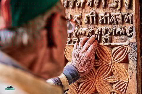 A wooden panel with Tankri script