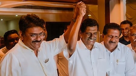 Kerala Congress chairman and Thodupuzha MLA P J Joseph raises the hand of his son and party state coordinator Apu John Joseph.