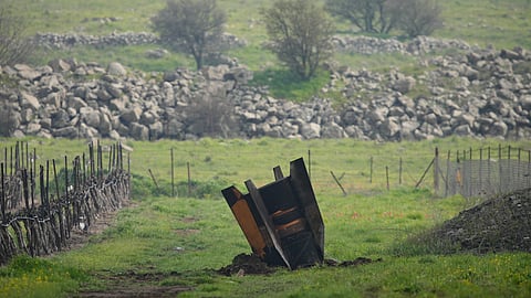 A fragment of a missile fired from Iran and intercepted by the Israeli defence system sticks out in an open field in the Israeli-controlled Golan Heights, Thursday, March 19, 2026.