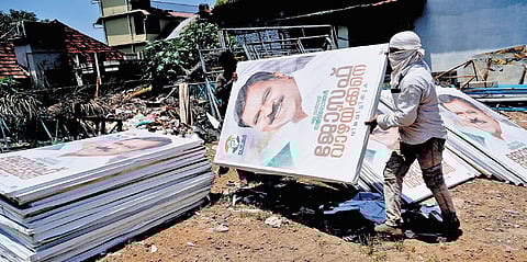 Flex boards that were printed for Joseph Vazhakkan being removed by workers in the Ettumanoor constituency in Kottayam district on Friday.