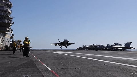 A US fighter jet lands on an aircraft carrier deployed in West Asia during Operation Epic Fury.