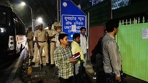Police personnel outside the United News of India's (UNI) office after it was sealed, citing a high court order, Friday, March 20, 2026. 