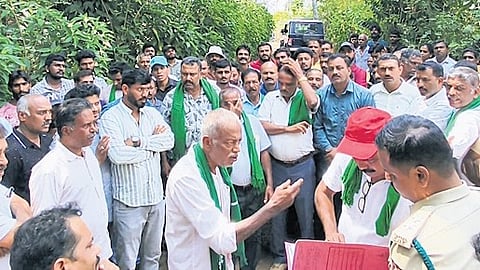 Farmers face off forest department staff during eviction process 