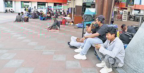 A few migrant labourers from Assam wait at the Coimbatore railway station on Friday to catch the train to their native places.