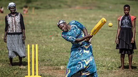An elderly woman plays a shot during a cricket and physical training session in Jinja, on January 10, 2026.