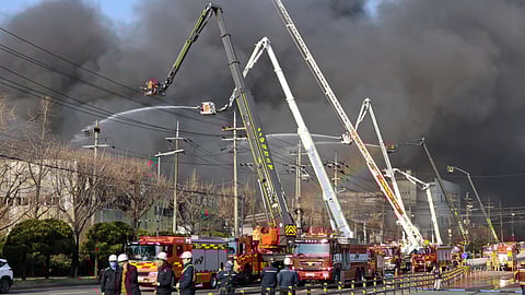 Black smoke rises from an auto parts plant in Daejeon, South Korea, Friday, March 20, 2026.