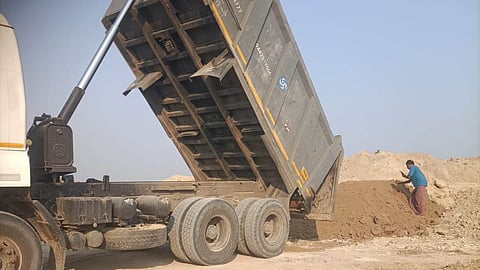 Farmers have been protesting against quarrying of soil from Karisal Kulam tank, a key irrigation source. Soil is sourced for bridge construction along NH.