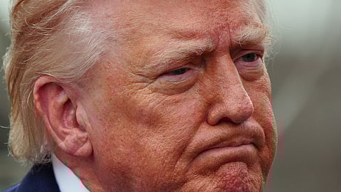 President Donald Trump speaks with reporters before departing on Marine One from the South Lawn of the White House, Friday, March 20, 2026, in Washington. 