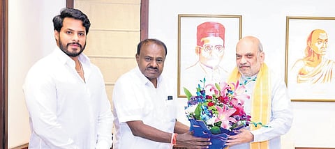 Union Minister HD Kumaraswamy greets Union Home Minister Amit Shah 
in New Delhi. JDS leader Nikhil Kumaraswamy accompaied his father