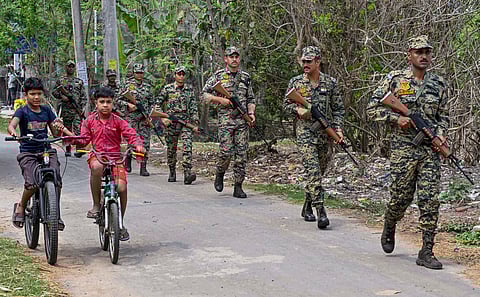 Border Security Force (BSF) personnel conduct a route march following the announcement of the West Bengal Assembly election dates, in Nadia, Thursday, March 19, 2026. 