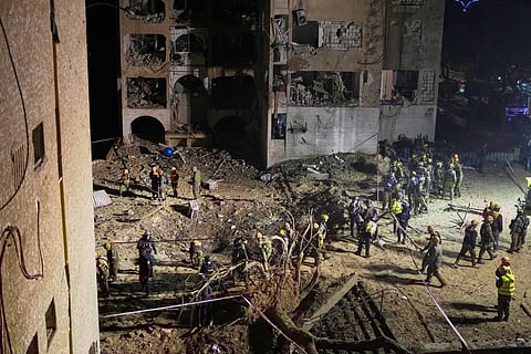 Israeli security forces and rescue teams work at the site struck by an Iranian missile in Arad, southern Israel, Sunday, March 22, 2026.