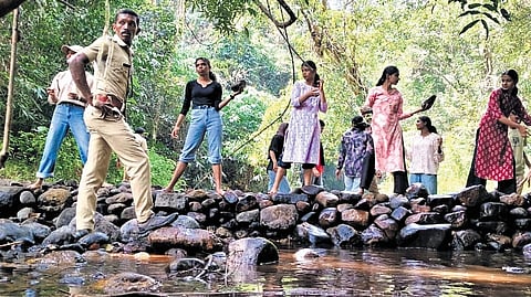 Volunteers of a forestry club along with forest officials building a check dam inside the forest in Goodrical Forest Range, Ranni.