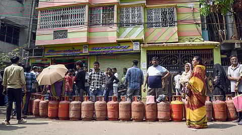 People wait in a queue outside a gas agency to refill the LPG cylinders amid reports of a nationwide shortage of LPG in Kolkata, March 13, 2026.