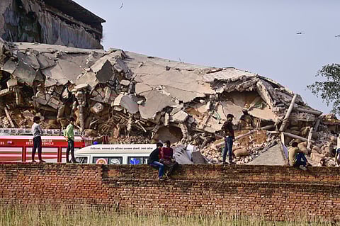 People gather as a rescue operation is underway after a cold storage building collapsed, at Phaphamau, in Prayagraj district, Uttar Pradesh, Monday, March 23, 2026. At least 20 people were feared trapped under debris even as rescue operations were under way. 