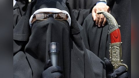 Separatist and Dukhtaran-e-Millat (Daughters of the Nation) leader Asiya Andrabi holds a knife during a protest march to the Martyrs' Graveyard in Srinagar on June 7, 2009.