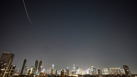 Missiles launched from Iran streak across the sky over central Israel, early Tuesday, March 24, 2026.