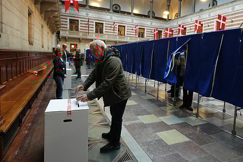 A man casts a ballot at a polling station at City Hall in Copenhagen, Denmark, on Tuesday, March 24, 2026, during the general election.