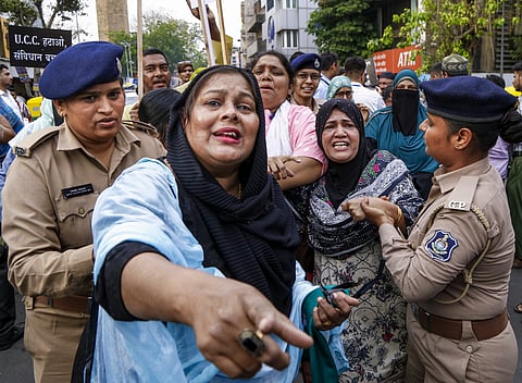 Police personnel detain AIMIM activists during a protest against the Gujarat Uniform Civil Code (UCC) Bill, 2026, in Ahmedabad, Tuesday, March 24, 2026. 