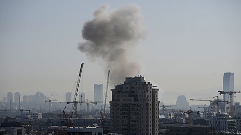 Smoke billows following an Iranian missile strike in Tel Aviv, Tuesday, March 24, 2026.