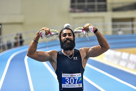Gurindervir Singh celebrates after winning the men's 60m race