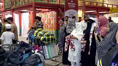 In this photo from March 5, 2026, Indian passengers reunite with their family members as they arrive safely from a flight from Jeddah amid flight disruptions in the wake of the conflict in West Asia.