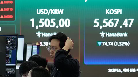 Currency traders watch monitors near a screen showing the Korea Composite Stock Price Index (KOSPI), right, and the foreign exchange rate between U.S. dollar and South Korean won at the foreign exchange dealing room of the Hana Bank headquarters in Seoul, South Korea, Thursday, March 26, 2026.