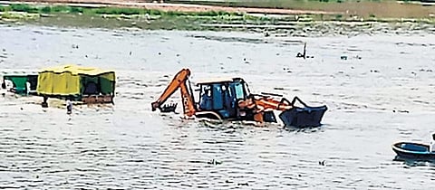 A videograb of the tractor being pulled out using a crane 