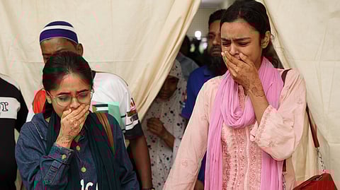 Relatives of victims break down at Rajbari Government Hospital, the day after a passenger bus plunged into the Padma river while boarding a ferry in Rajbari district, about 84 kilometers (52 miles) from the capital Dhaka, Bangladesh, Thursday, March 26, 2026.