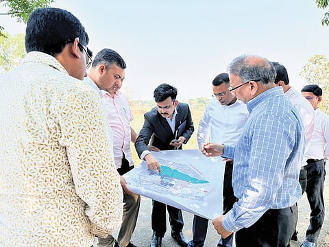 Vishal Dev going through a map of the proposed IT Park in Sambalpur 