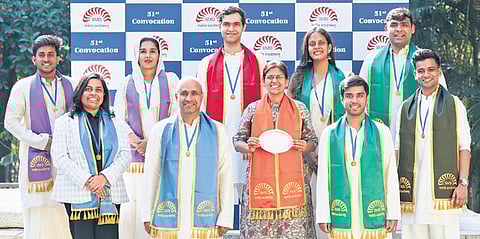 Divya Dwivedi (centre, with award), and nine gold medalists from various disciplines 
at the 51st convocation of IIMB on Friday 