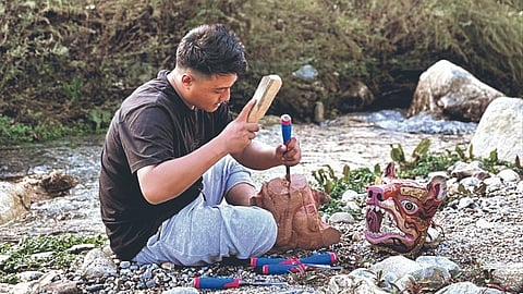 A mask maker in Shergaon