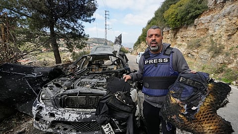 A journalist carries burnt safety gear, following an Israeli airstrike on a car that killed Hezbollah's Al-Manar TV correspondent Ali Shoeib; Beirut-based Al-Mayadeen TV reporter Fatima Ftouni; and her brother, video journalist Mohammed Ftouni, in the town of Jezzine, south Lebanon, on Saturday, March 28, 2026.