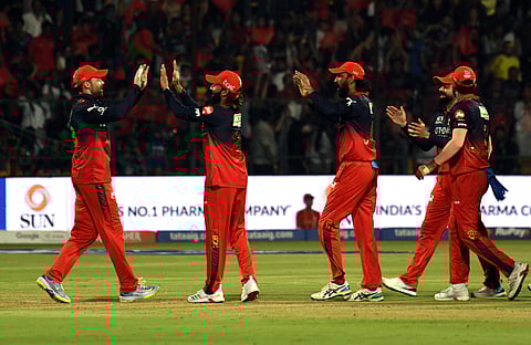 RCB players celebrate the wicket of Abhishek Sharma