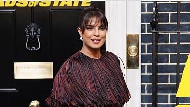 Priyanka Chopra Jonas in a burgundy, leather-trimmed fringe dress from Burberry