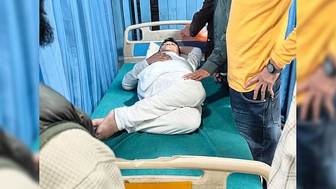 In a social media video, he was seen lying on the ground, groaning, and surrounded by people, including police personnel.