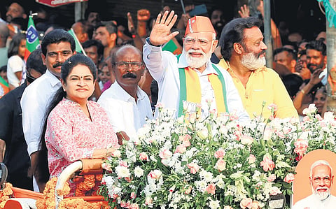 Prime Minister Narendra Modi greets the crowd during a roadshow held as part of NDA’s poll campaign in Thrissur on Sunday. Union Minister Suresh Gopi and NDA candidates Padmaja Venugopal, K K Aneeshkumar and C C Mukundan look on 