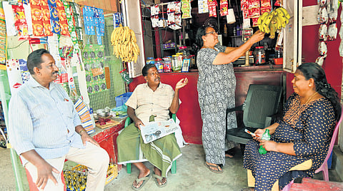 Munambam residents engaging in a political discussion at a shop in the area 