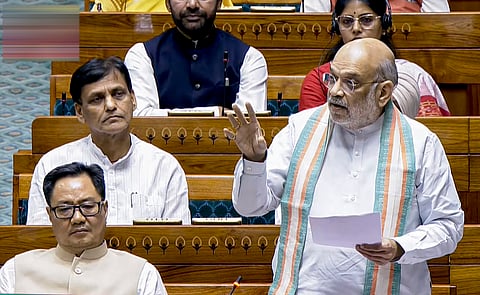 Union Home Minister Amit Shah speaks in the Lok Sabha during the second part of the Budget session of Parliament, in New Delhi, Monday, March 30, 2026. Union Minister Kiren Rijiju, front left, is also seen.