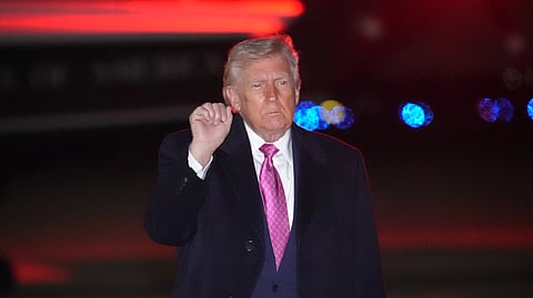 US President Donald Trump gestures after stepping off Air Force One, Sunday, March 29, 2026, at Joint Base Andrews, Md.