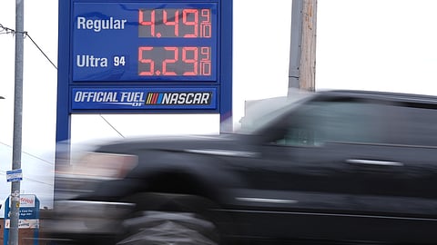 A vehicle passes a gasoline price board at a filling station in Philadelphia, Friday, March 27, 2026.