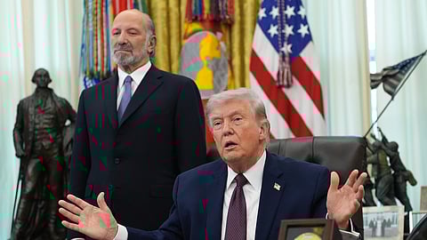 President Donald Trump answers questions from reporters after signing an executive order in the Oval Office of the White House Tuesday, March 31, 2026, in Washington, as Commerce Secretary Howard Lutnick listens.