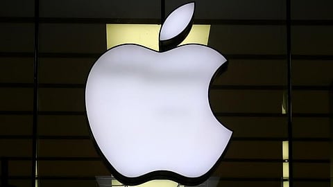 The logo of Apple is illuminated at a store in the city center in Munich, Germany.