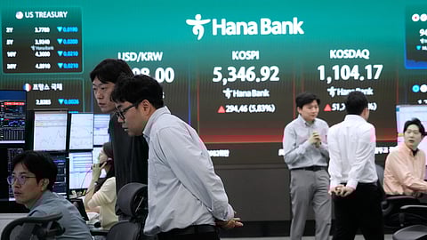 Currency traders work at the foreign exchange dealing room of the Hana Bank headquarters in Seoul, South Korea, Wednesday, April 1, 2026.